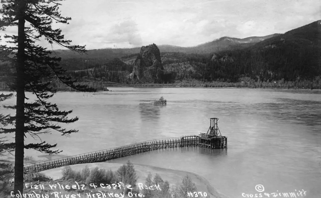 Circa 1915, Beacon Rock (once known as Castle Rock) viewed across the Columbia River from what is now known as the Historic Columbia River Highway. A fish wheel is visible in the foreground. Photo courtesy of the U.S. Forest Service.