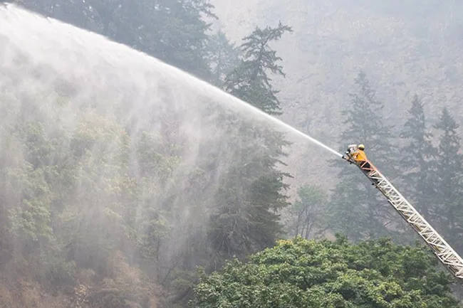 A City of Portland fire crew douses part of the Eagle Creek fire near Multnomah Falls. (photo courtesy of Multnomah County Communications)
