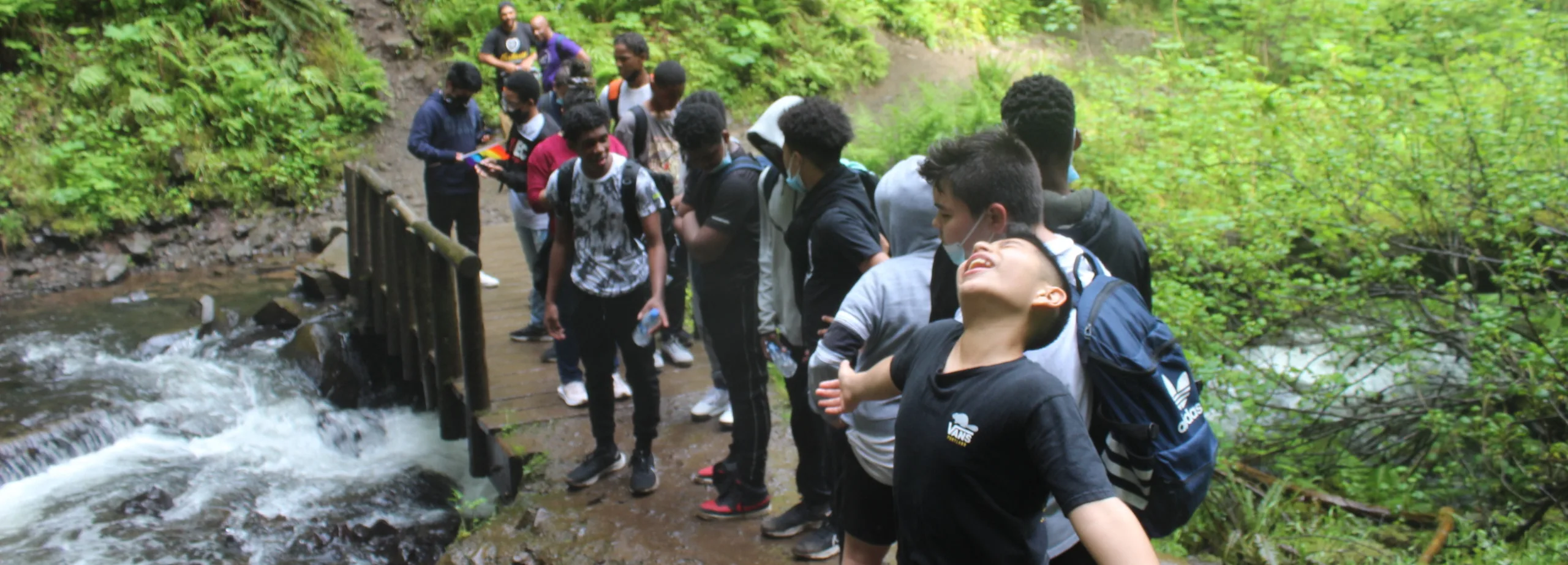 St. Andrew students pause to bask in a stream's cooling mist on the trail to Upper Latourell Falls. (photographer: Stan Hall)