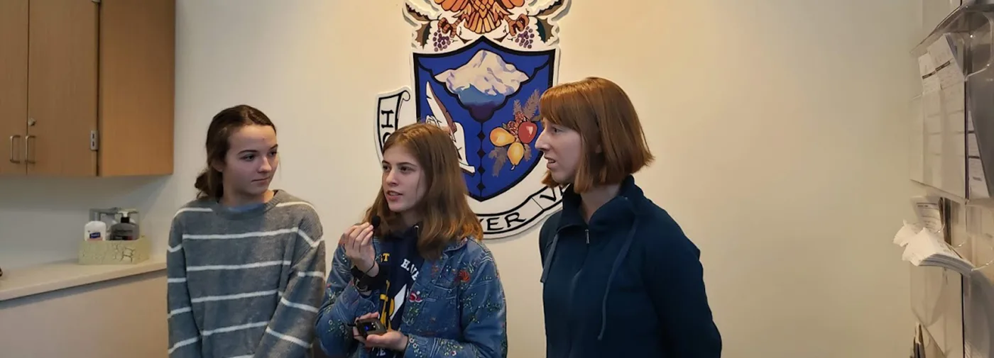 (from left to right) Hood River Valley High School Climate Action Club members Lottie Bromham, Lillie Tomlinson and Lyric Emmons give an interview about their activism, Dec. 2019. (photographer: Peter Cornelison)