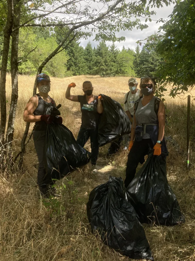 Masked volunteers remove loads of invasive tansy ragwort on U.S. Forest Service land near Friends' Turtle Haven preserve. (photographer: Sarah Skelly)
